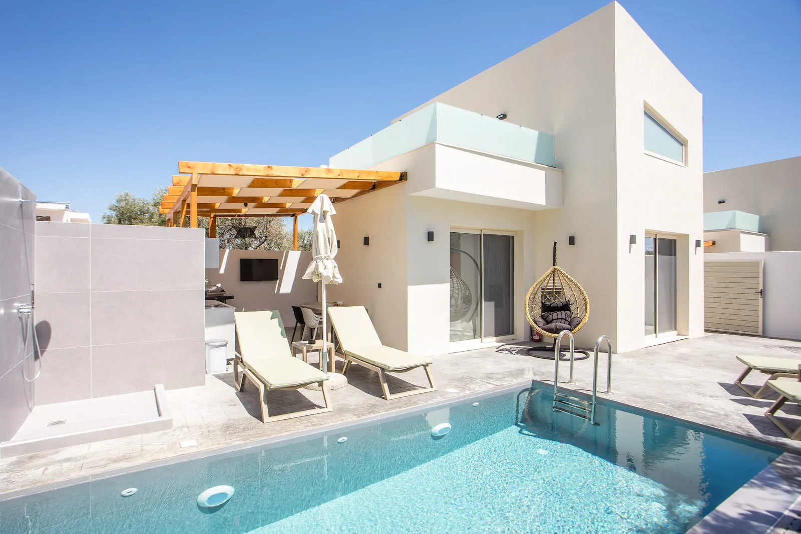 Pool with sunbeds and umbrellas